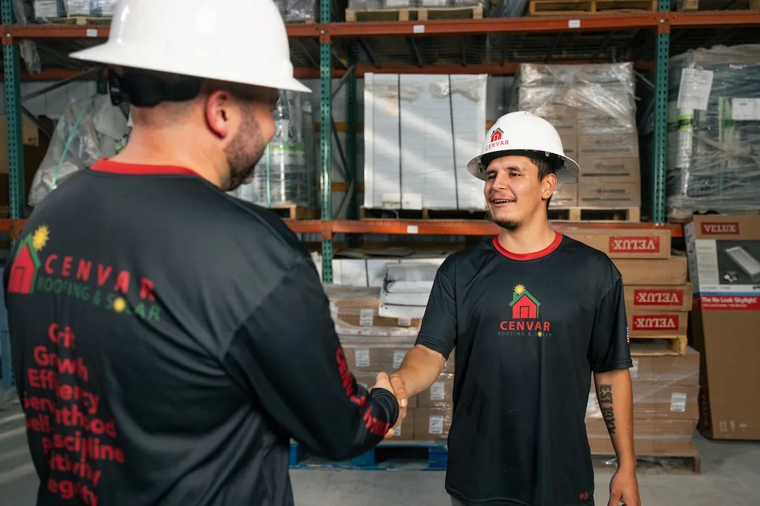 Cenvar team members shaking hands at the company warehouse